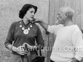 Pablo Picasso with Madame Paule de Lazerme – she had an affair with Pablo Picasso for some months – who wears a necklace designed by Pablo Picasso, made with the help of the Vallauris dentist Dr. Chatagnier. In front of the studio Le Fournas, Vallauris 1953. - Photo by Edward Quinn